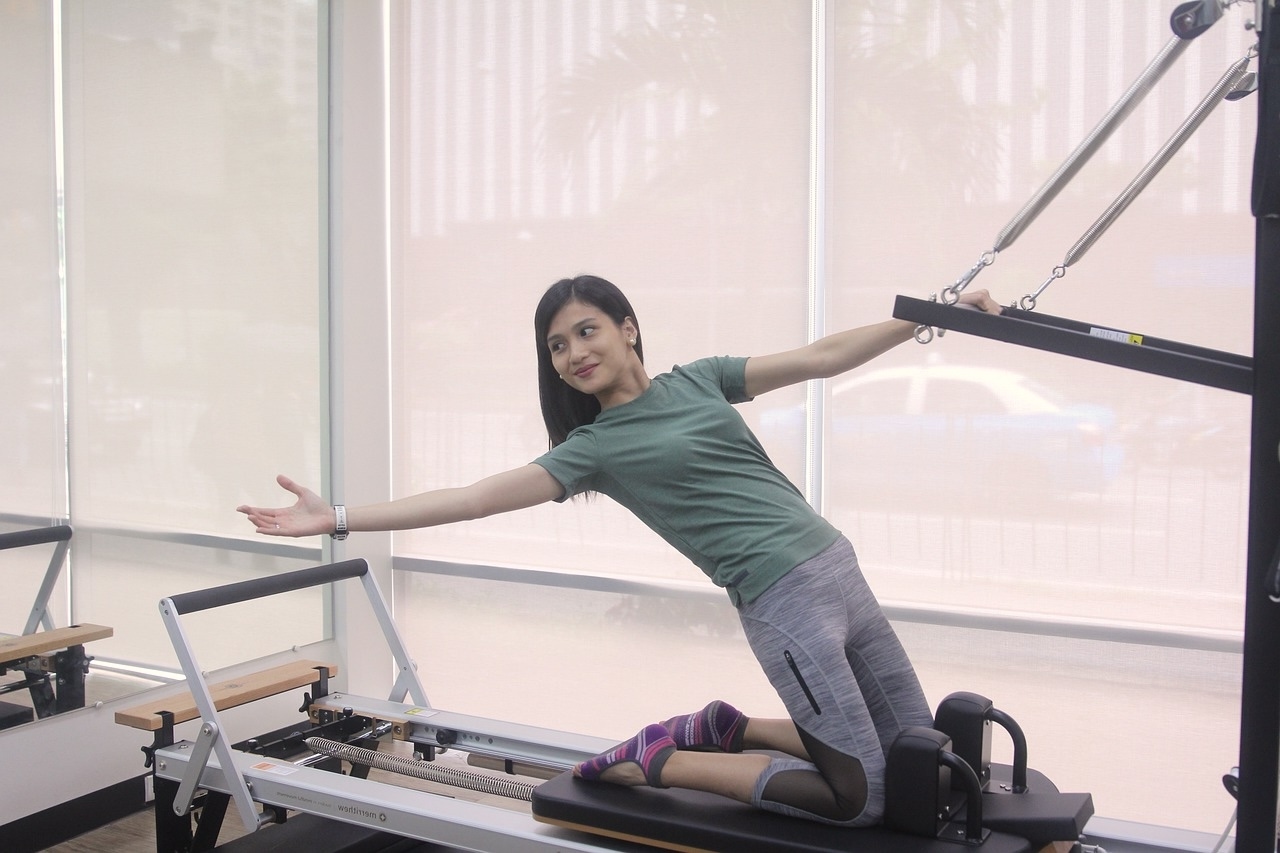 woman using a pilates reformer