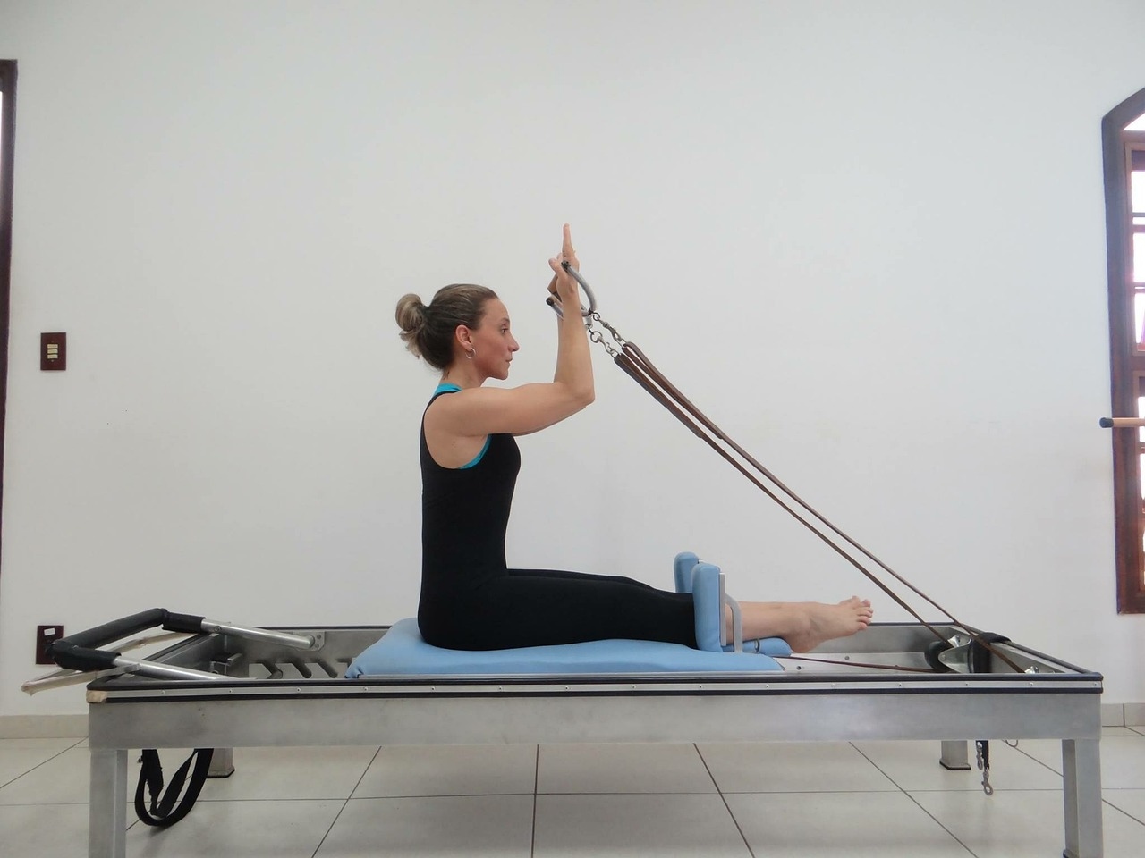 woman using a pilates reformer