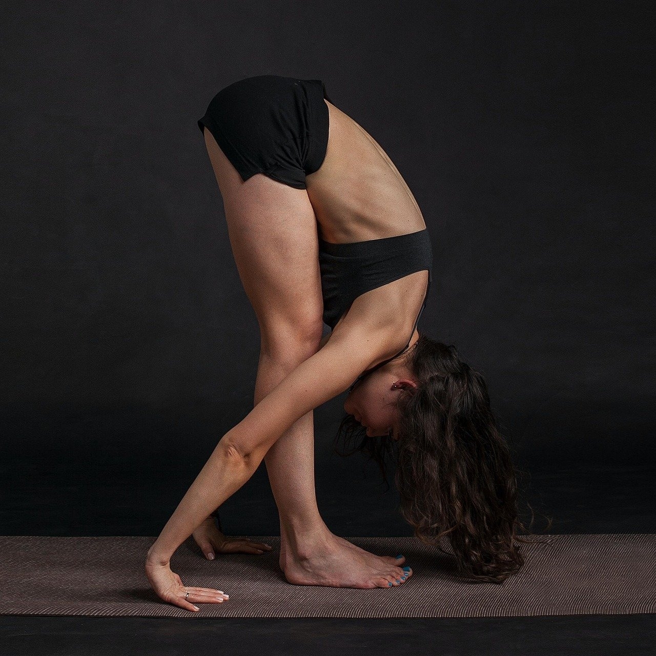 woman doing yoga in a bent over pose